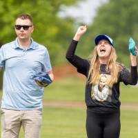 Chelsea Farley raises her hands celebrating next to Coleman Brott